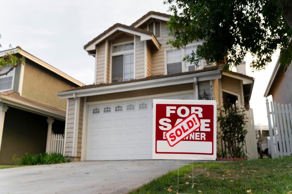 A house with a sold sign in the yard.