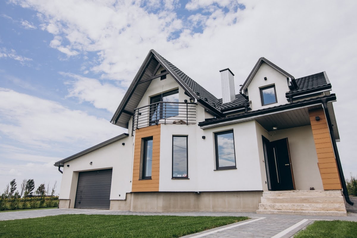 A modern house with big windows, a garage, and a front yard.
