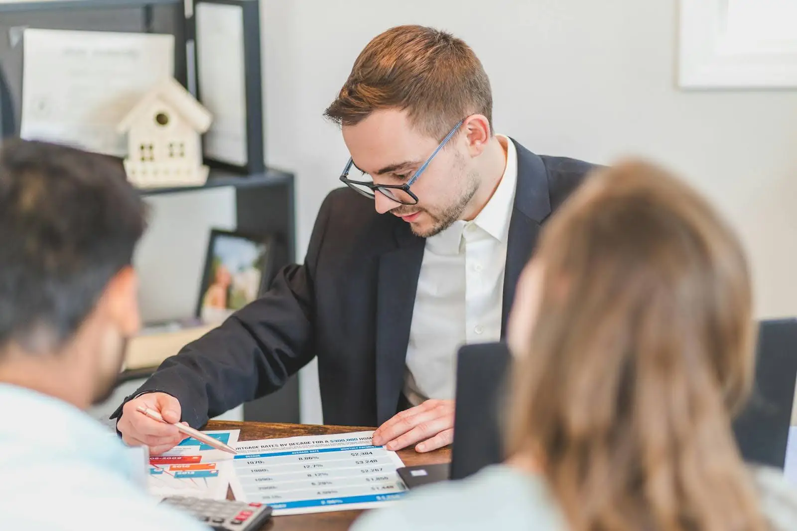 A family consulting with their realtor about selling their home in Utah.